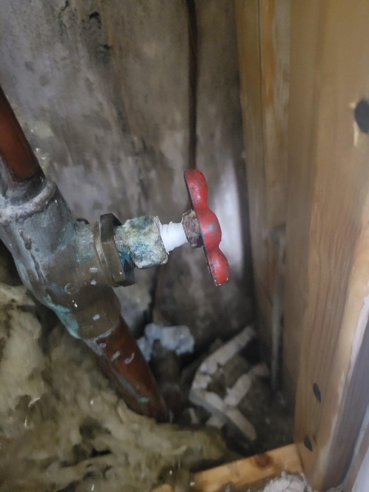 Old copper supply pipe with a shut-off valve at a Niagara Region home